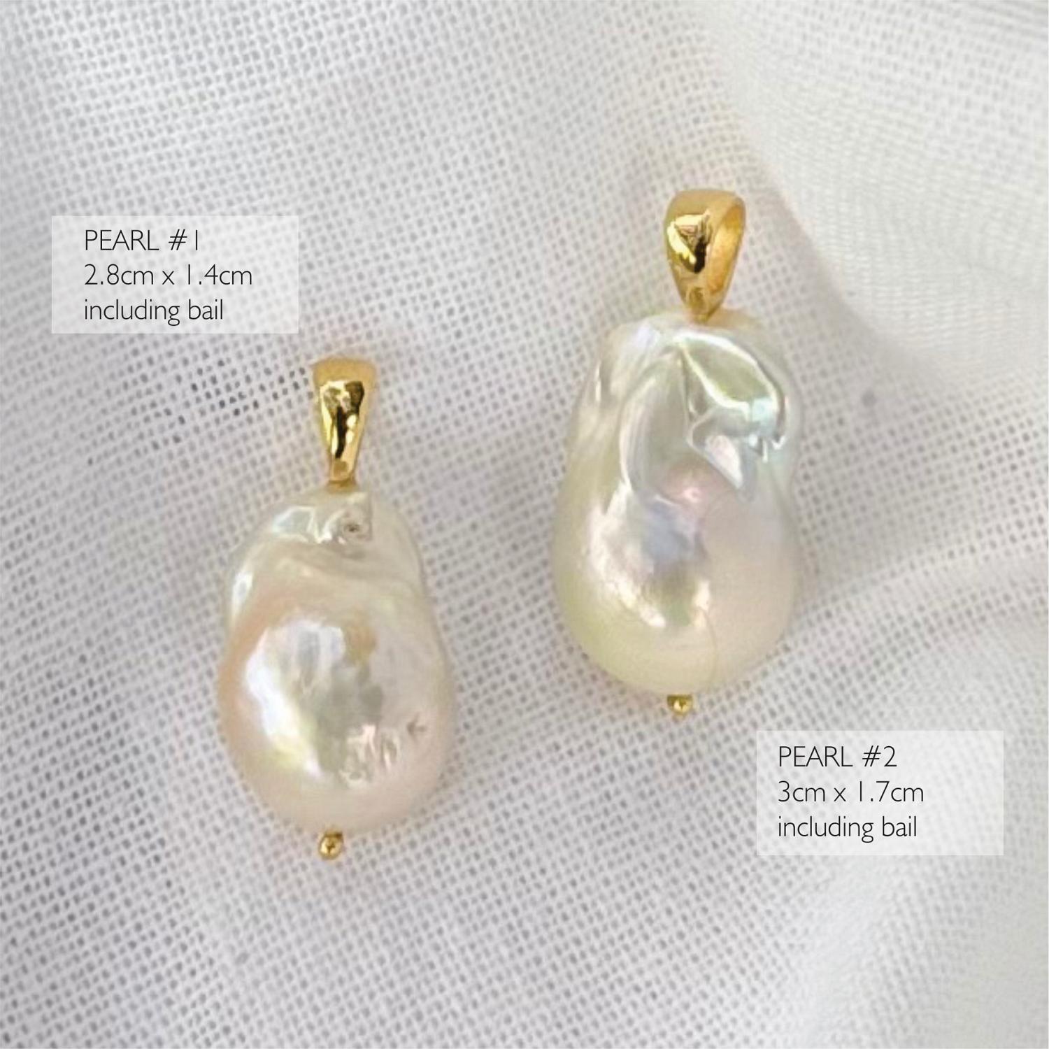 Two excellent quality large baroque pearl pendants with gold bail settings.
