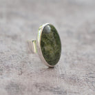 Silver ring with a large green stone 